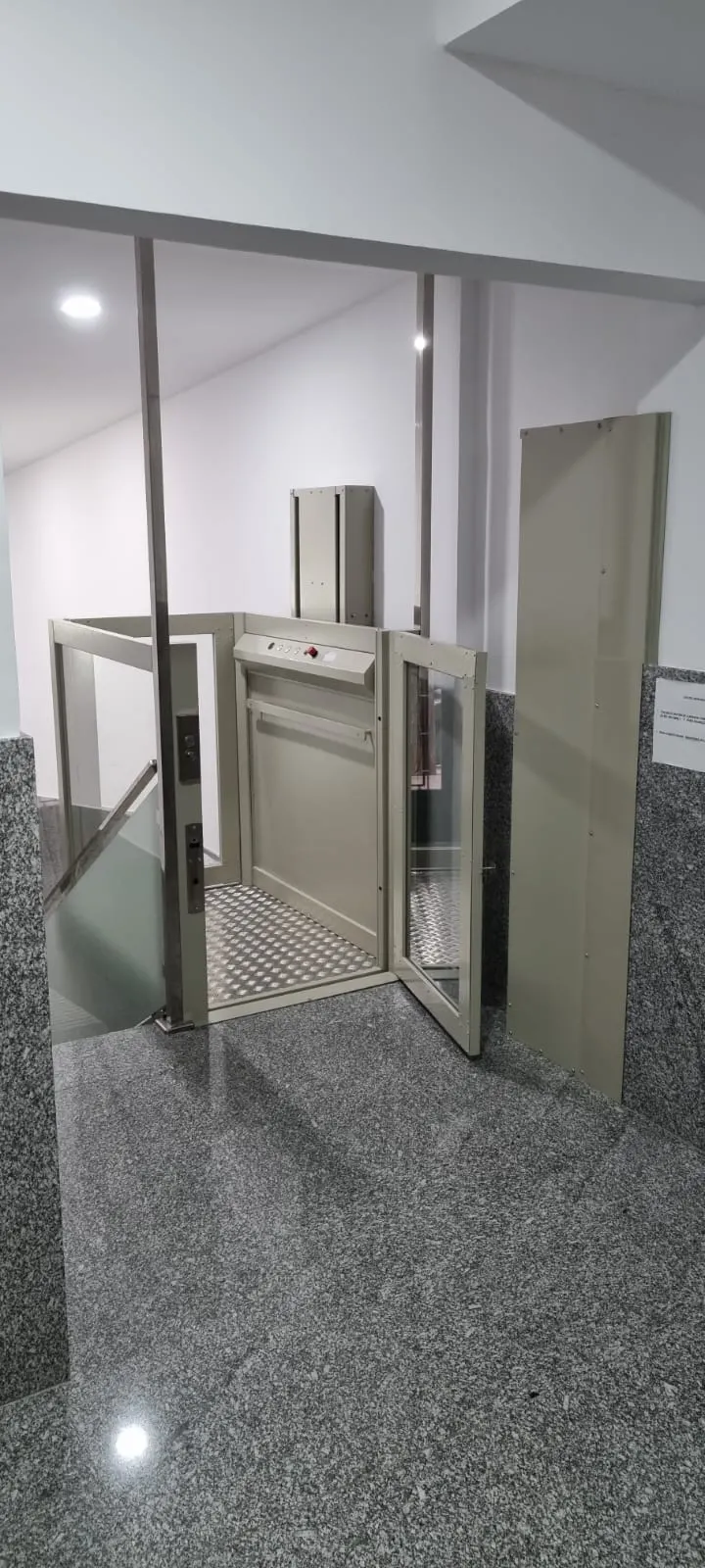 OnLevel PV30 platform lift on polished granite with gate open showing the platform floor