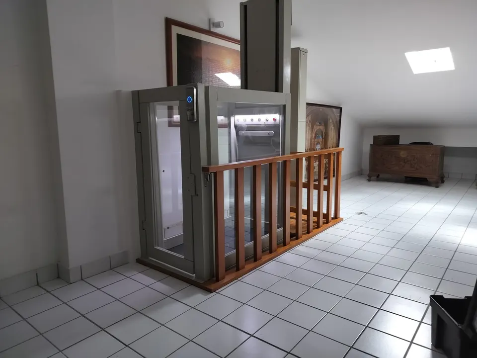 Glass OnLevel PV30 platform lift with warm timber balustrade in a tiled hallway