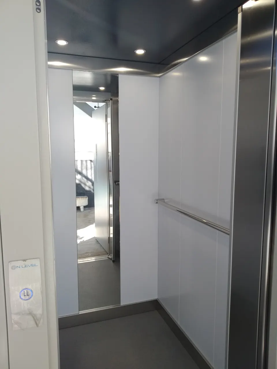 Bright white OnLevel TV300 cabin interior with vertical mirror and stainless handrail
